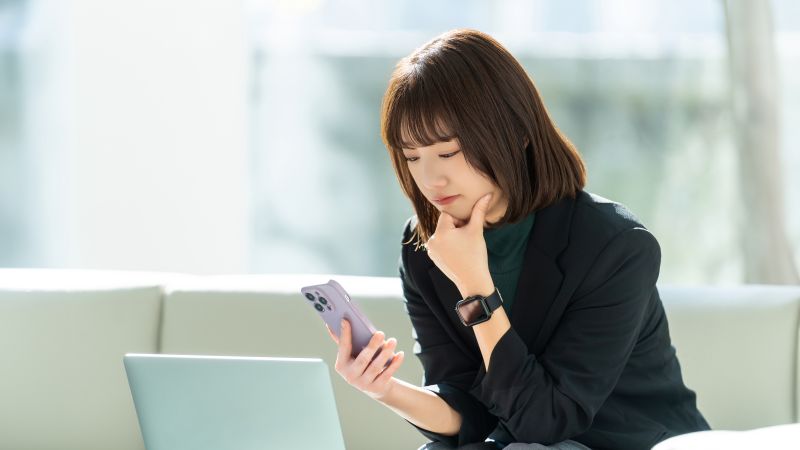 thoughtful asian woman on phone 800